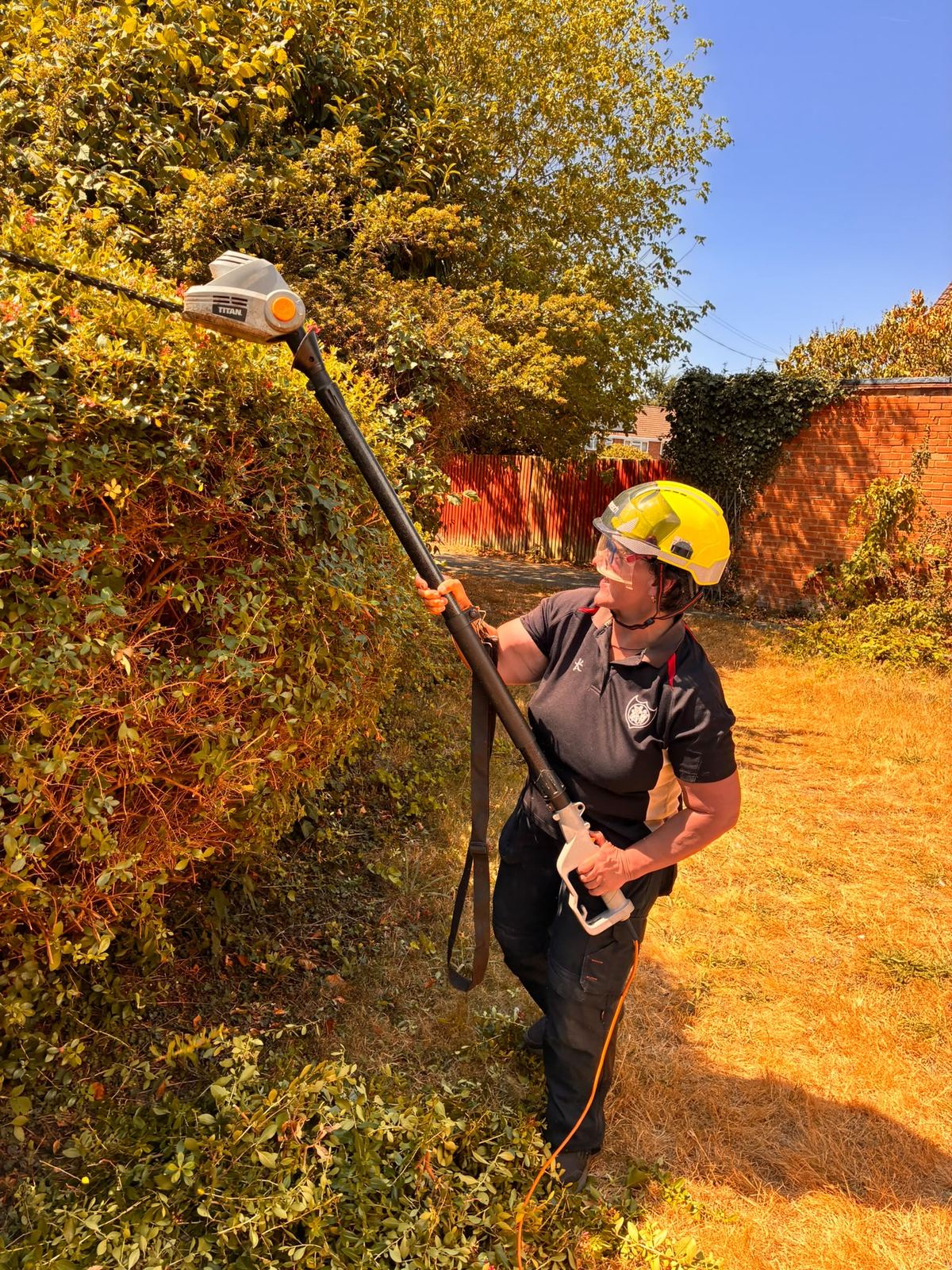 Louise carrying out hedge maintenance